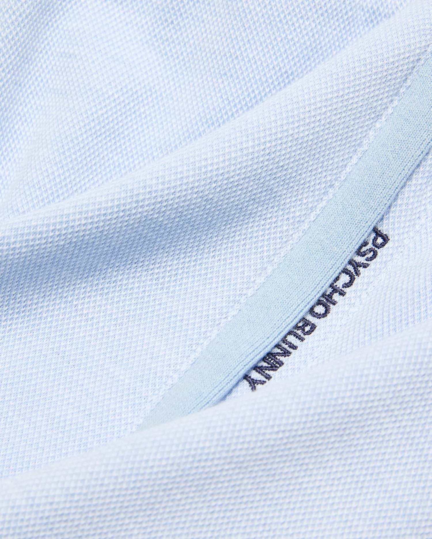 Light blue pique knit Kids Keith Short, showcasing premium streetwear with dark blue embroidered PSYCHO BUNNY text on a subtle lighter blue trim. (6)