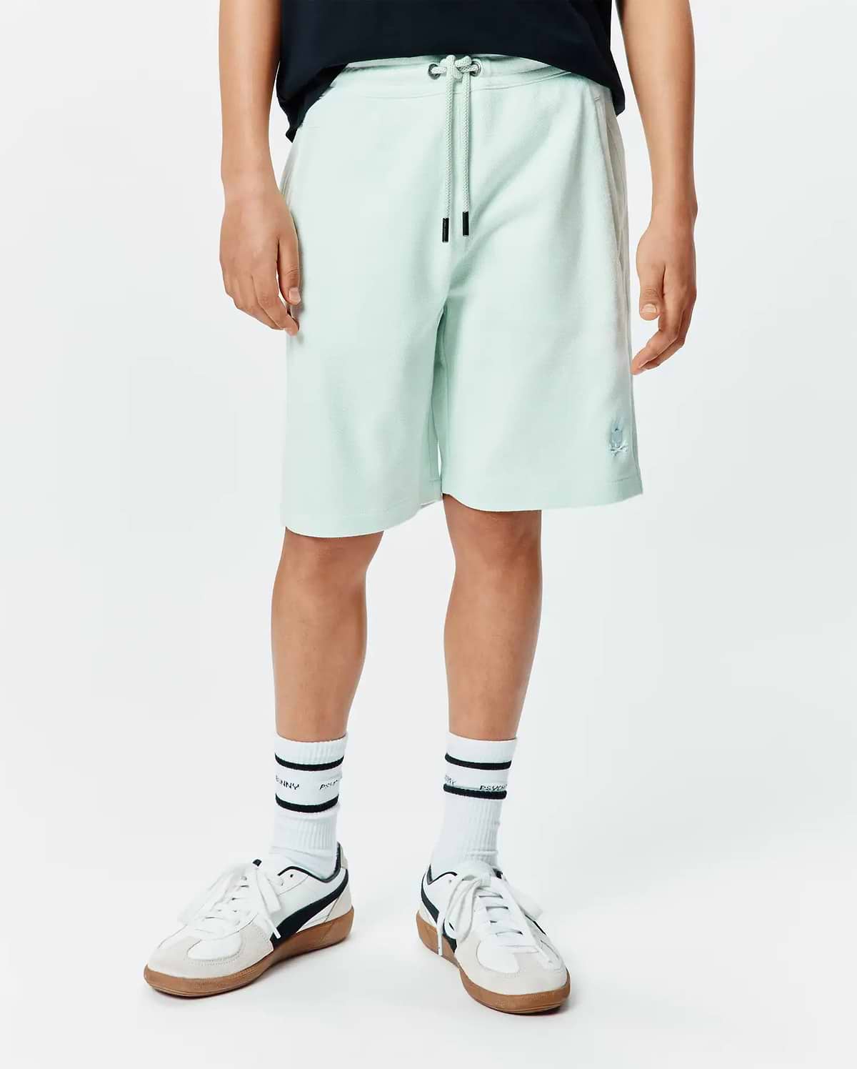 Kids Keith Short in light mint green pique knit, featuring a relaxed fit, drawstring waist with black tips, and a small embroidered Psycho Bunny skull logo on the lower left leg. (1)