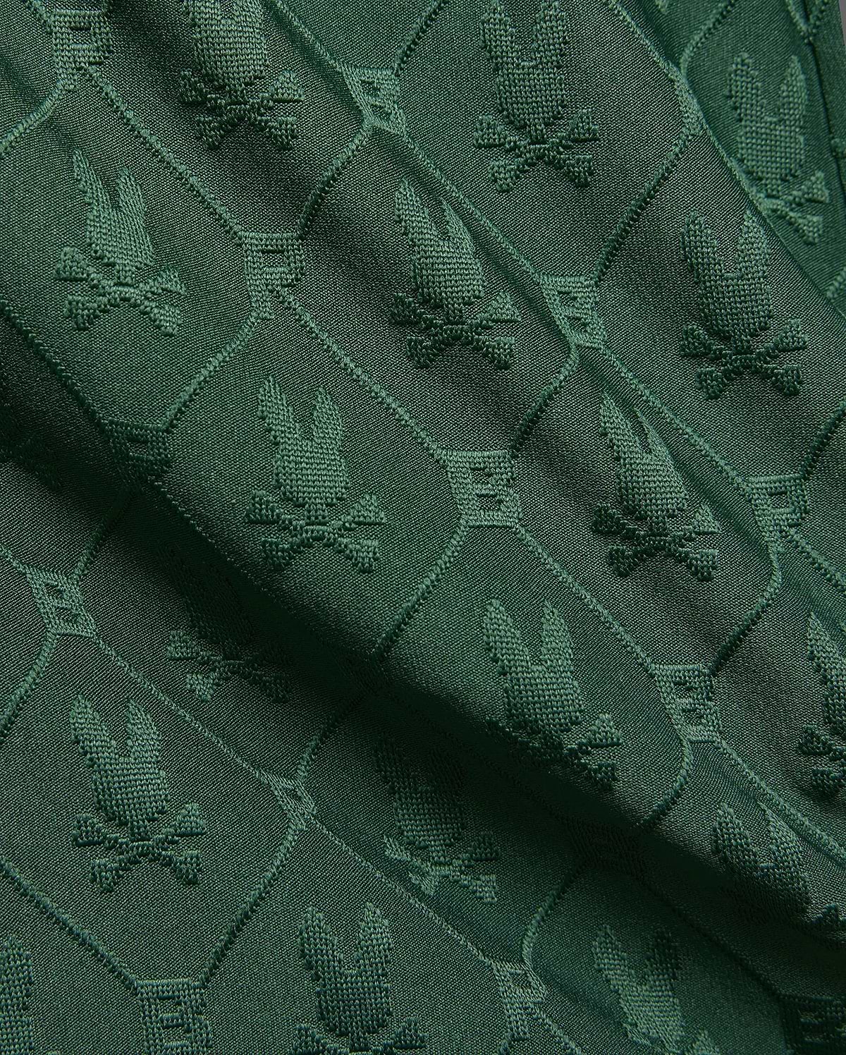 Kids Garry Jacquard Sweatshort in deep forest green, featuring an all-over textured jacquard knit pattern of the iconic Psycho Bunny skull logo within diamond shapes.
