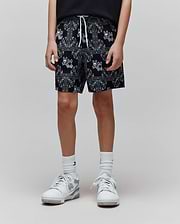 Kids Luke Swim Trunk in black with an all-over white bandana print featuring the Psycho Bunny skull logo, relaxed fit, and white drawstring.