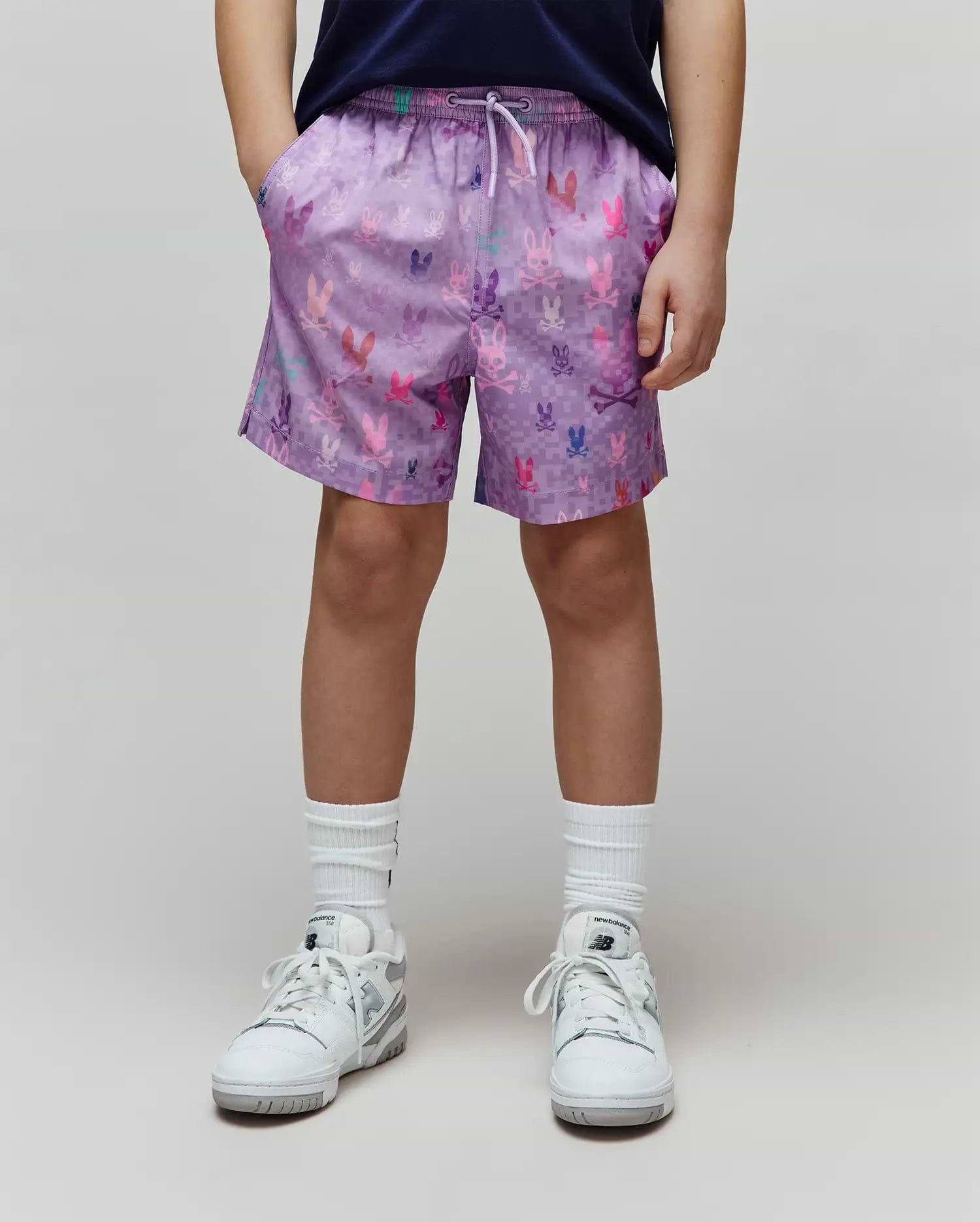 Lavender Kids Van Swim Trunk, relaxed fit, with a drawstring waist and an all-over multi-color pixelated Psycho Bunny skull logo print on quick-dry fabric.