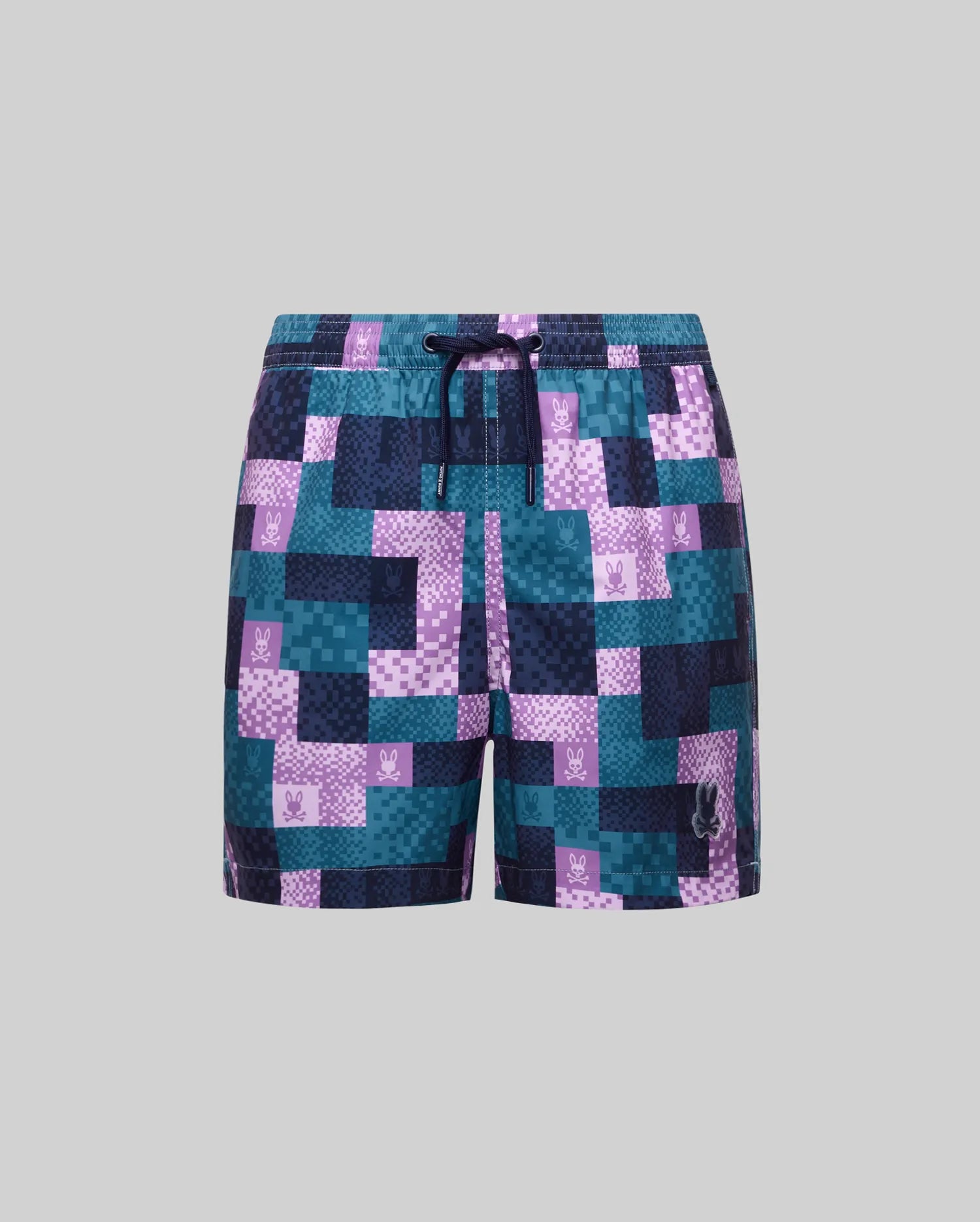 Kids Olivier All Over Bunny Swim Trunk with a pixelated teal, purple, and navy pattern, all-over bunny skull logo print, drawstring waist, and a larger embroidered logo.