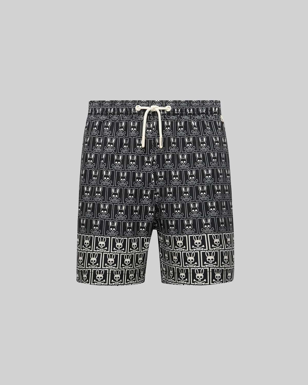 Kids Keon Swim Trunk in black, featuring a bold all-over white Psycho Bunny skull logo grid pattern and a contrasting white drawstring. This relaxed-fit swim trunk is designed for comfort. (5)