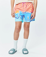 Kids Ray Swim Trunk 6 with a vibrant graphic print featuring an orange and pink striped sunrise over blue ocean waves, accented by playful Psycho Bunny skull logos in goggles floating on inner tubes.
