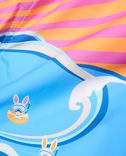 Kids Ray Swim Trunk 6, a vibrant blue swim trunk with a playful wave pattern, featuring repeated Psycho Bunny skull graphics wearing snorkel gear, accented by a bold pink and orange striped top.