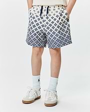 Kids Tobias Swim Trunk, cream with a navy blue all-over geometric pattern of the iconic Psycho Bunny skull logo, relaxed fit, smooth quick-dry fabric, and a navy drawstring. (1)