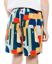 Kids Wes All Over Print Swim Trunk, a vibrant multi-color abstract geometric pattern in blue, green, orange, yellow, with repeated small Psycho Bunny skull logos and a back patch pocket on smooth, quick-dry fabric.