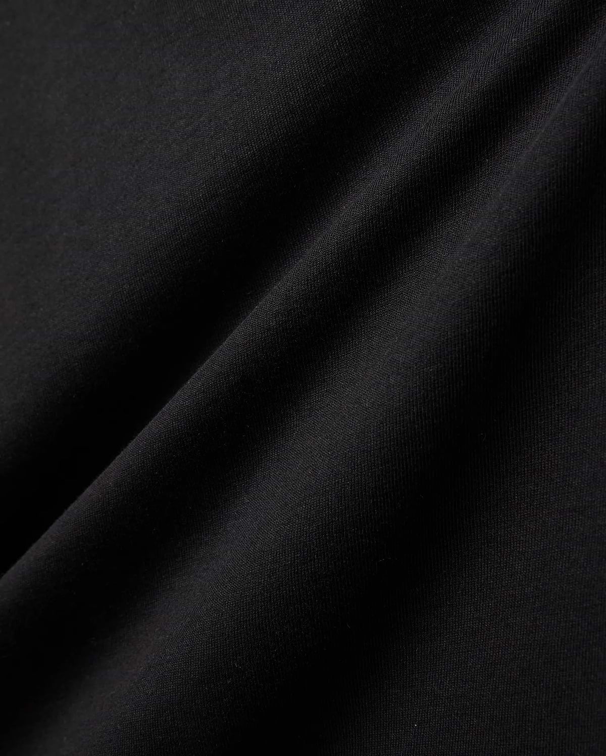 Kids Gordley Mix Media Jacket, a premium Psycho Bunny piece in deep black, showcasing a luxurious, soft-touch jersey knit fabric with subtle texture and elegant draping folds, hinting at refined streetwear style.