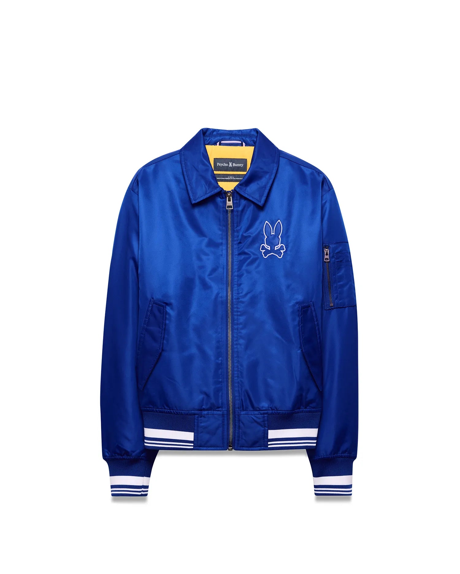 Kids Nathaniel Satin Coach Jacket in vibrant blue satin with a relaxed fit, featuring a white embroidered Psycho Bunny skull logo on the left chest, white striped ribbed cuffs and hem, and a full zip closure.