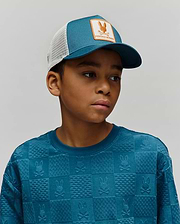 Kids Adamo Trucker Cap, teal front, white mesh, orange Psycho Bunny skull logo patch, and a teal crewneck sweatshirt with an embossed checkerboard Psycho Bunny skull pattern.