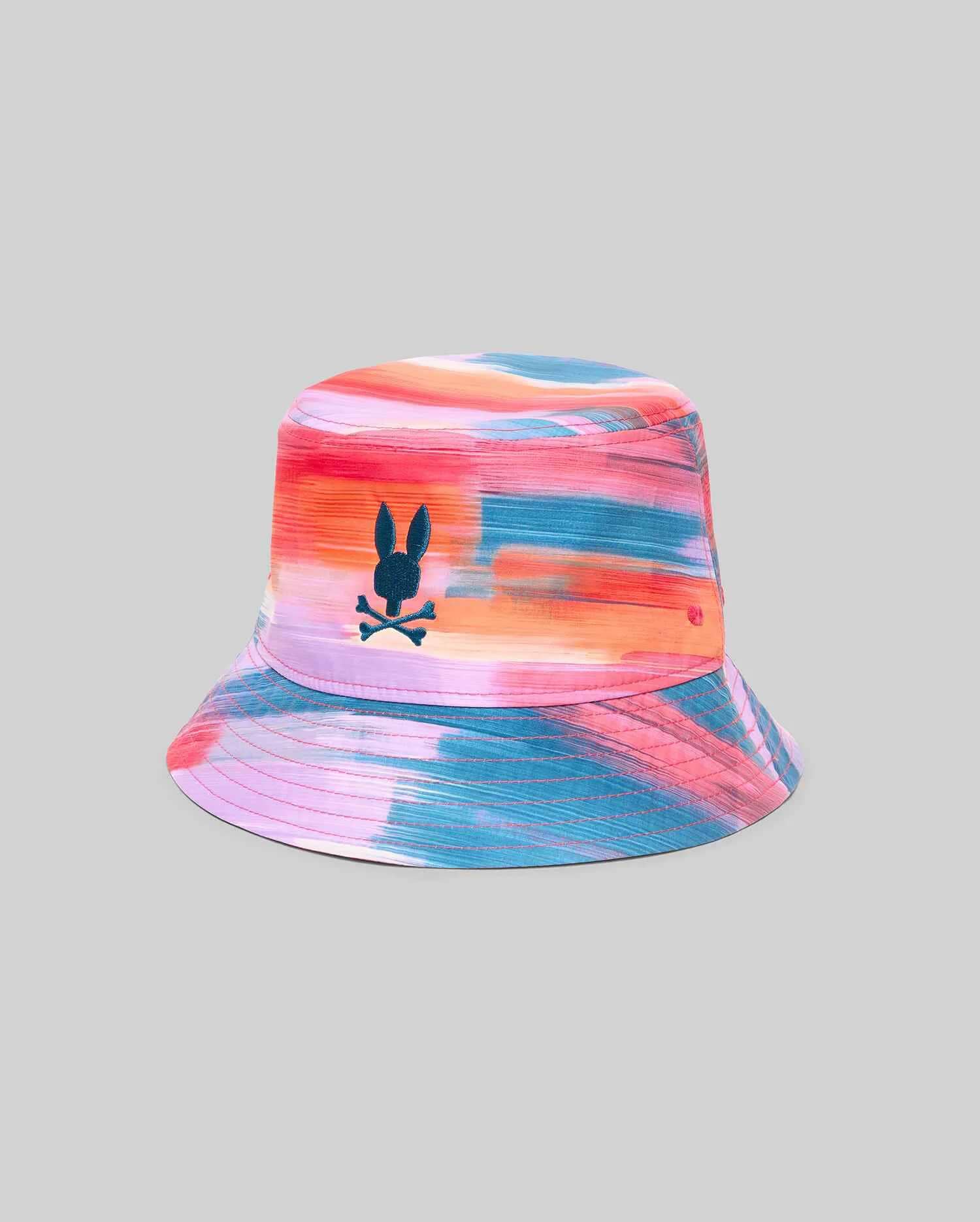 Kids Raphael Bucket Hat featuring a vibrant multi-color brushstroke pattern in pink, orange, blue, and purple, with a small embroidered teal Psycho Bunny skull logo on the front.