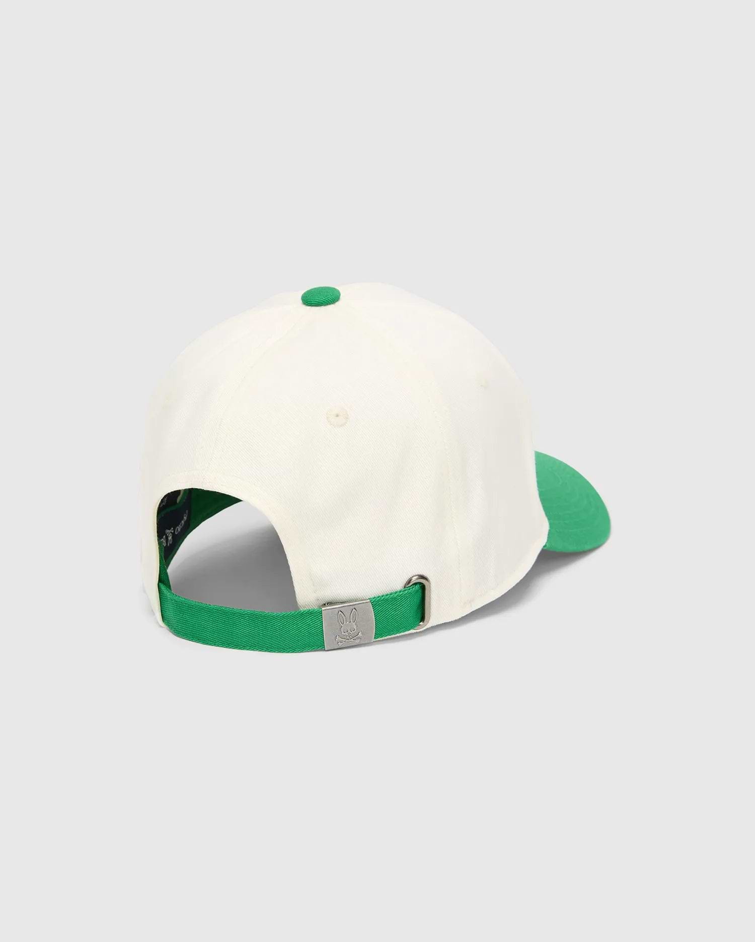 Kids Craig Baseball Cap in cream cotton twill with a vibrant green brim, top button, and adjustable strap featuring an embossed Psycho Bunny skull logo on the silver-tone metal buckle.