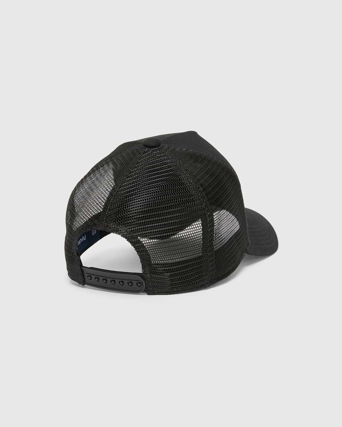 Black Kids Isaac Trucker Cap featuring a breathable mesh back, solid front panel, adjustable snapback closure, and a small inner Psycho Bunny brand tag.