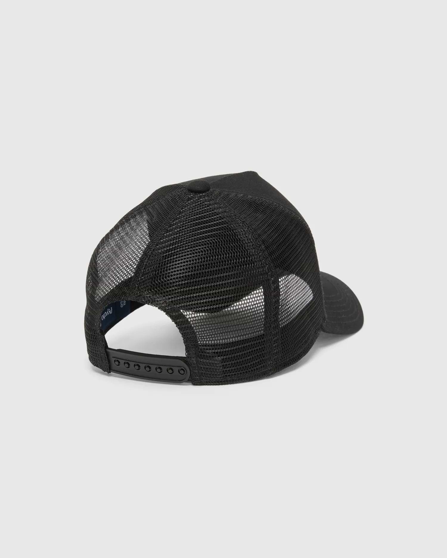 Black Kids Isaac Trucker Cap featuring a breathable mesh back, solid front panel, adjustable snapback closure, and a small inner Psycho Bunny brand tag.