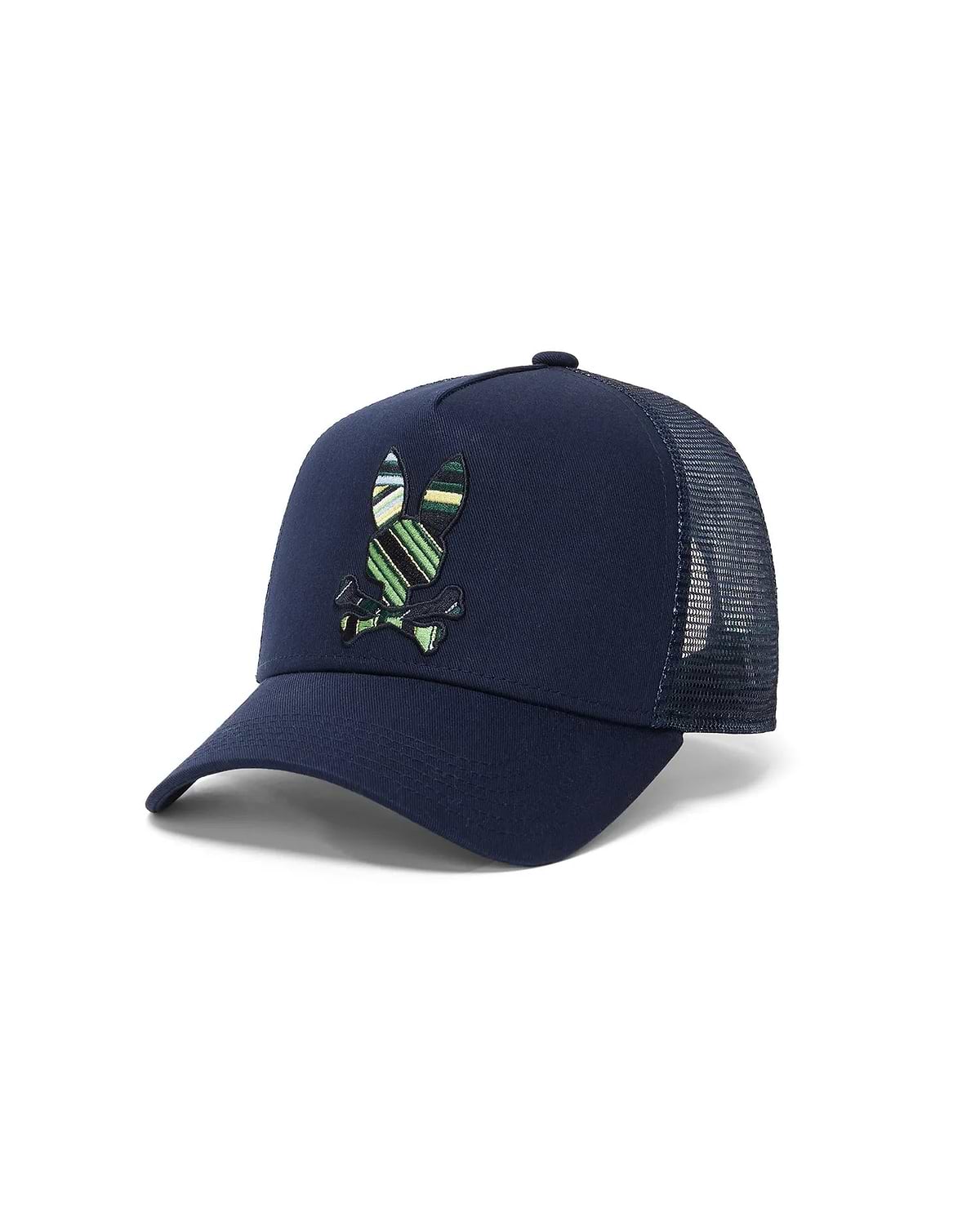 Kids Drew Trucker Cap in navy cotton twill with a mesh back, featuring a large, embroidered Psycho Bunny skull logo on the front with green, yellow, and white stripes.