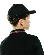 Black pique polo with red, white, and black striped collar, paired with a black Kids Jaydon Baseball Cap featuring a small Psycho Bunny skull logo on its adjustable metal buckle.