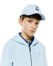 Light blue textured full-zip hoodie with small chest Psycho Bunny logo, dark blue patterned polo, and a Kids Jaydon Baseball Cap featuring a large embroidered Psycho Bunny skull with orange ears.