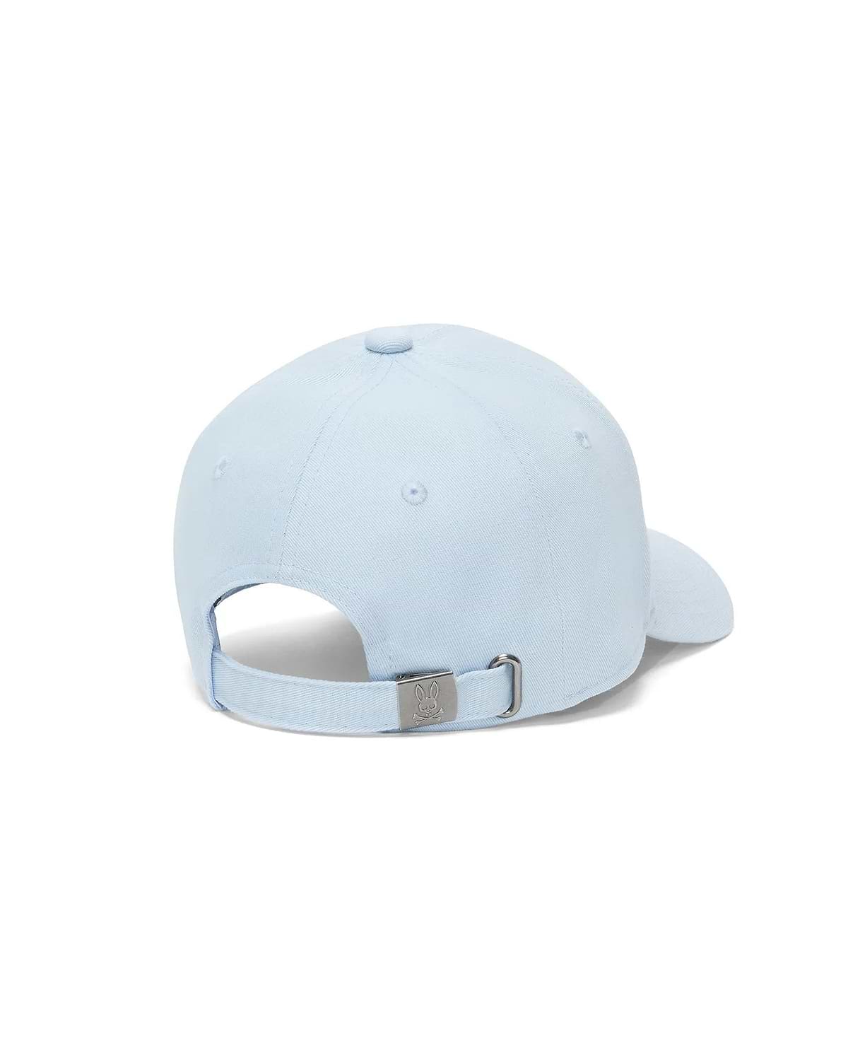 Kids Jaydon Baseball Cap in light blue cotton twill, featuring an adjustable strap and a silver-tone metal buckle engraved with the iconic Psycho Bunny skull logo at the back.