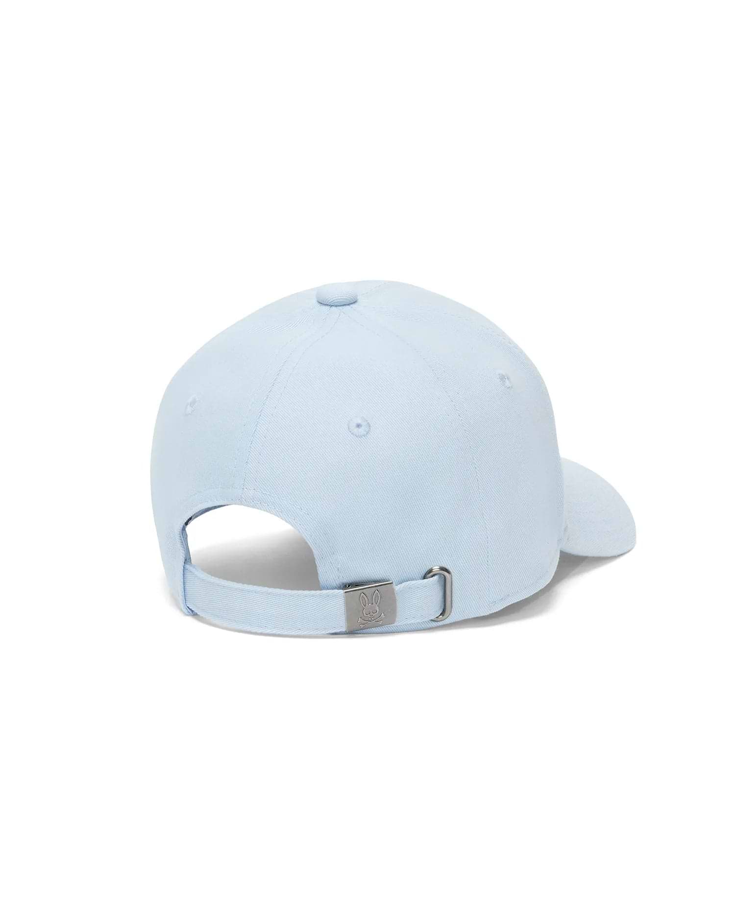 Kids Jaydon Baseball Cap in light blue cotton twill, featuring an adjustable strap and a silver-tone metal buckle engraved with the iconic Psycho Bunny skull logo at the back.