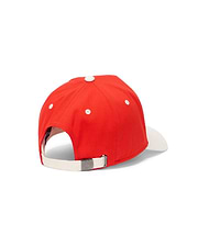 Kids Sable A-Frame Trucker Cap in vibrant red with a white brim, top button, and eyelets. Features a cream adjustable back strap with a small metal Psycho Bunny skull logo buckle.