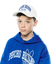 Royal blue relaxed hoodie with large white embroidered Psycho Bunny skull logo on chest, and a white Kids Nathaniel A-Frame Trucker Cap with blue embroidered Psycho Bunny New York text.