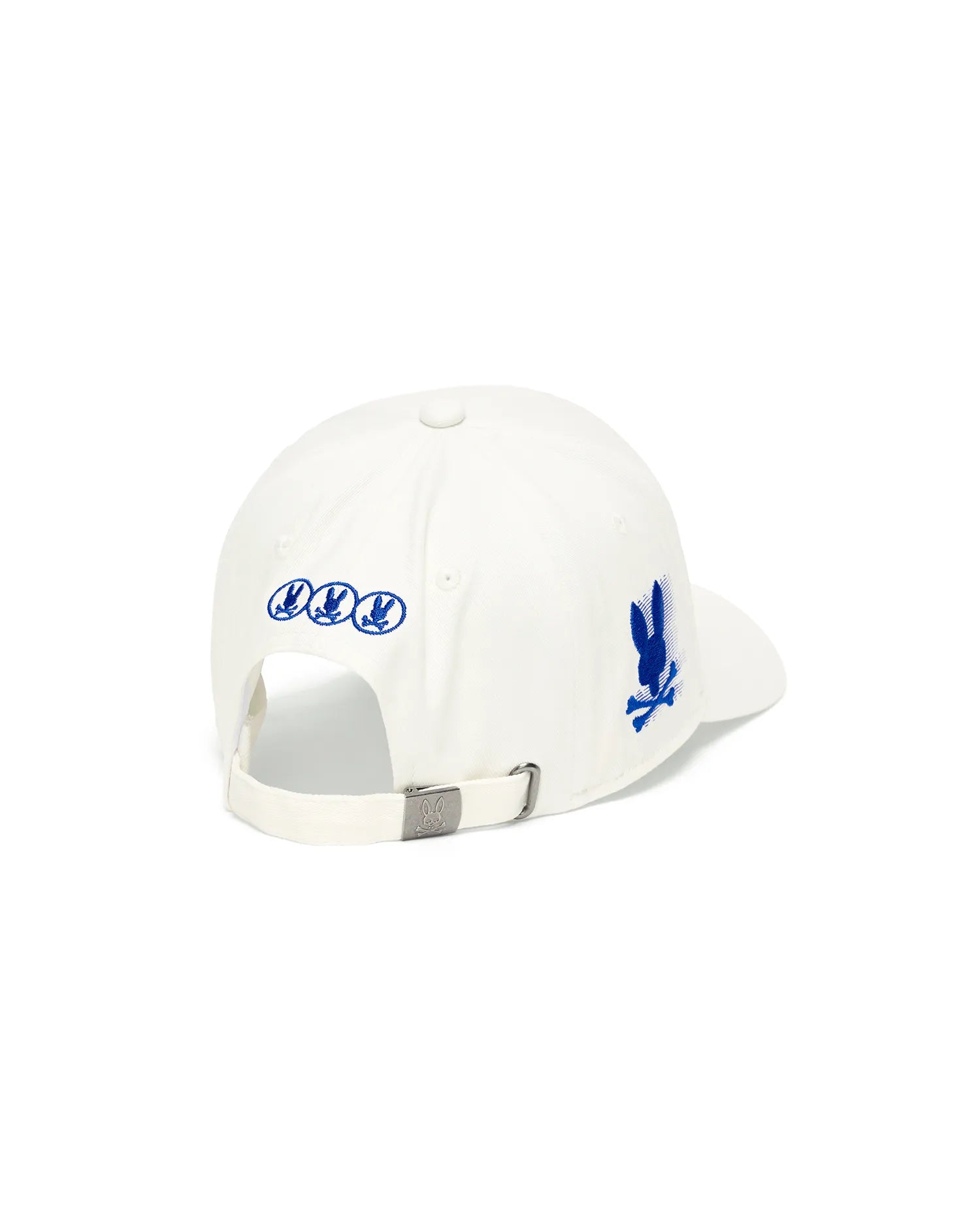 White Kids Nathaniel A-Frame Trucker Cap featuring a prominent blue embroidered Psycho Bunny skull logo on the right side, three smaller blue logos on the back, and an engraved logo on the metal buckle closure.