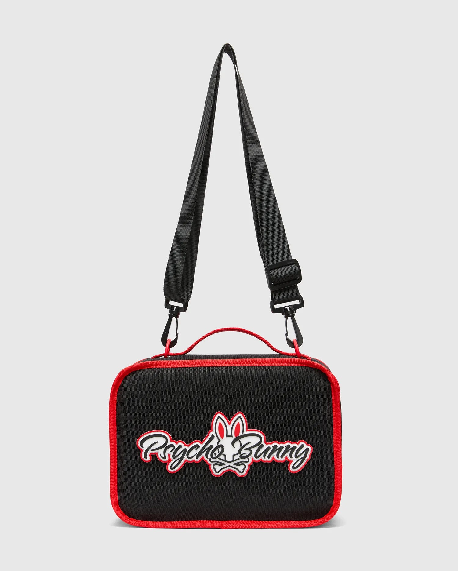 Kids Pal Lunch Box, black with vibrant red piping, featuring a prominent white and red embroidered Psycho Bunny skull logo on the front, complete with an adjustable black strap and red carry handle.
