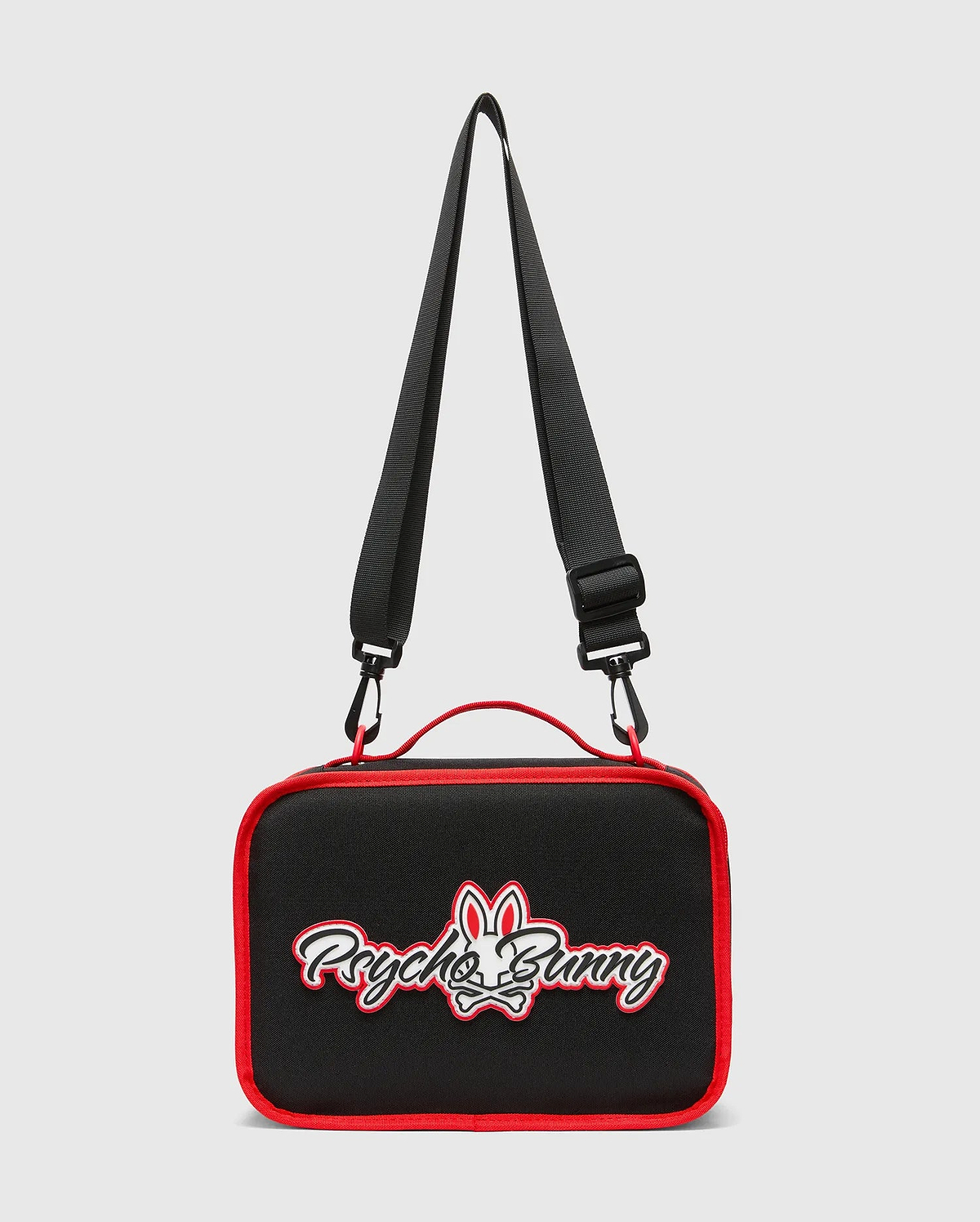 Kids Pal Lunch Box, black with vibrant red piping, featuring a prominent white and red embroidered Psycho Bunny skull logo on the front, complete with an adjustable black strap and red carry handle.