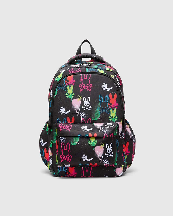 Kids Quintin Backpack, black durable woven fabric with an all-over vibrant neon graffiti print featuring multiple Psycho Bunny skull logos and paint splatters, front zip pocket.