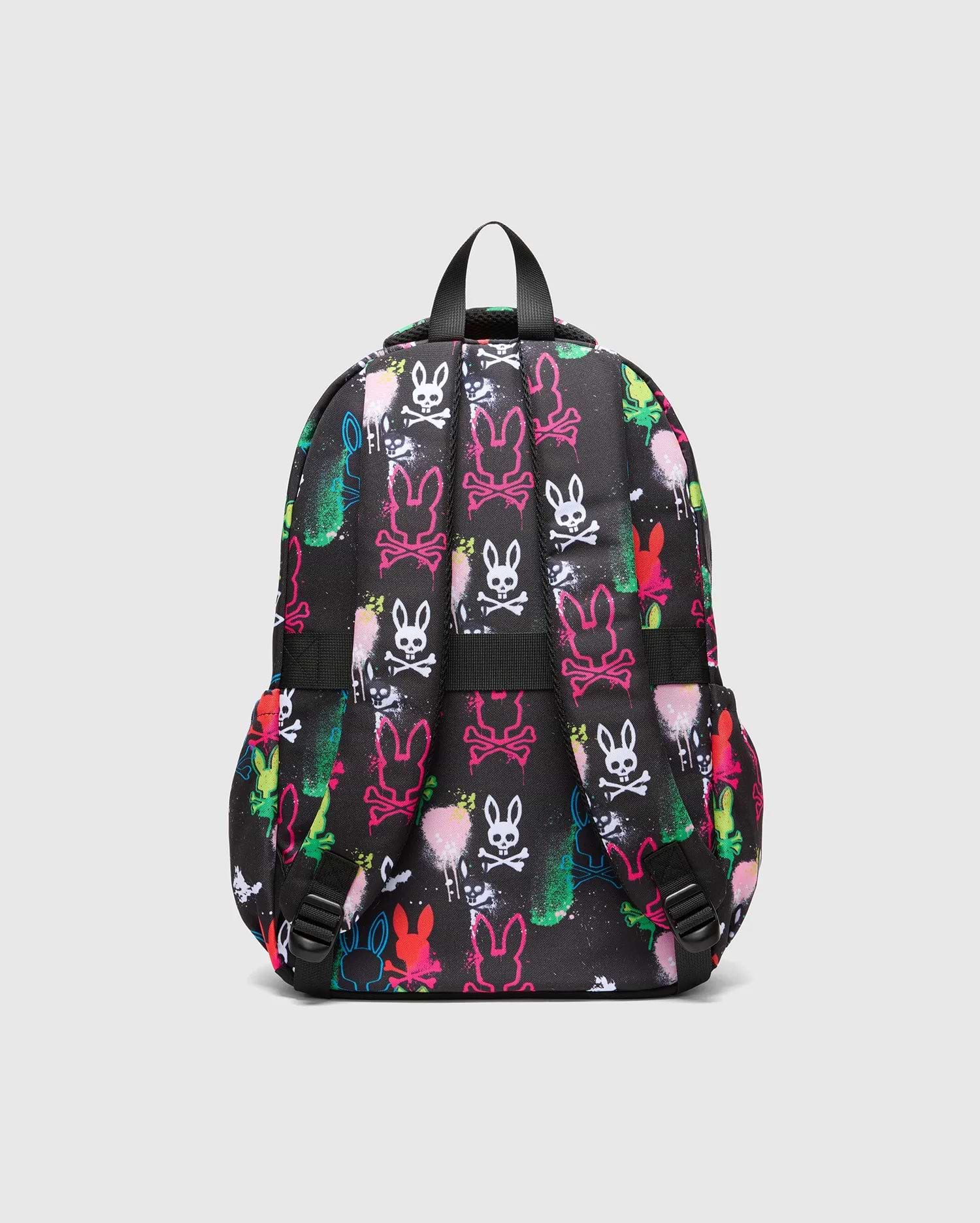 Kids Quintin Backpack, black with an all-over neon graffiti print featuring Psycho Bunny skull logos and outline bunny heads in vibrant pink, green, blue, yellow, white, and red, accented with spray paint splatters.