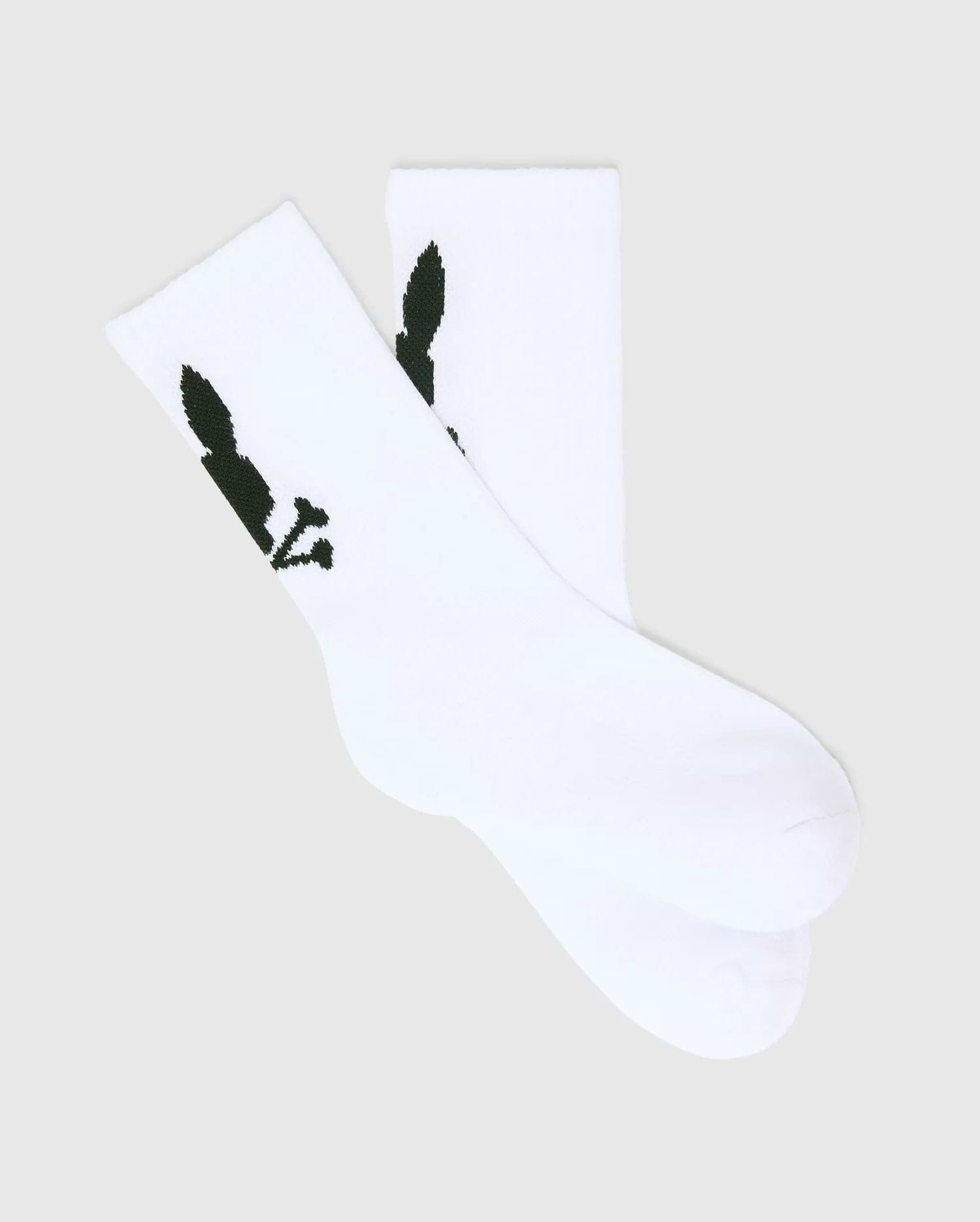 Kids 3 Pack Sport Socks in crisp white, crafted from a smooth knit fabric, featuring the iconic dark green Psycho Bunny skull logo prominently on the ankle cuff.