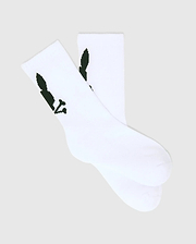 Kids 3 Pack Sport Socks in crisp white, crafted from a smooth knit fabric, featuring the iconic dark green Psycho Bunny skull logo prominently on the ankle cuff.