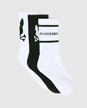 KIDS 3 PACK SPORT SOCKS in white and black, featuring large Psycho Bunny skull logos on two pairs and Psycho Bunny text with black stripes on one white pair, crafted from a smooth knit fabric.