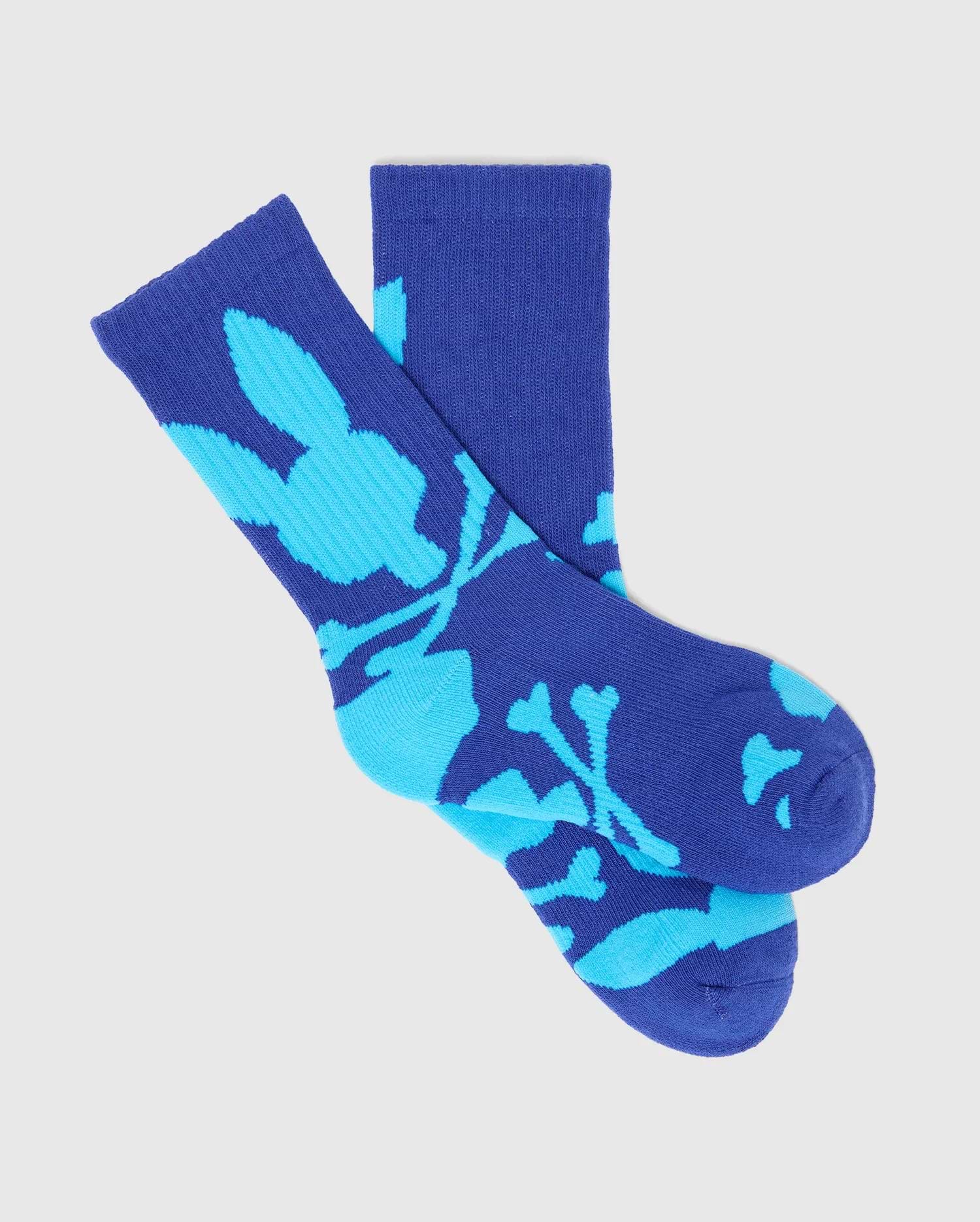Kids Sunny 3 Pack Sport Socks in royal blue with a light blue all-over Psycho Bunny skull and crossbones pattern, featuring a ribbed knit texture and crew length.