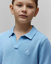 Kids Devon Bubble Stitch Knit Polo in light blue, featuring a textured bubble knit fabric, open V-neck collar, and a small, tone-on-tone embroidered Psycho Bunny skull logo on the left chest.