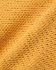 Kids Devon Knit Polo in bold golden-yellow, crafted from a premium, refined knit fabric featuring a distinctive micro-waffle texture, perfect for elevated streetwear style.
