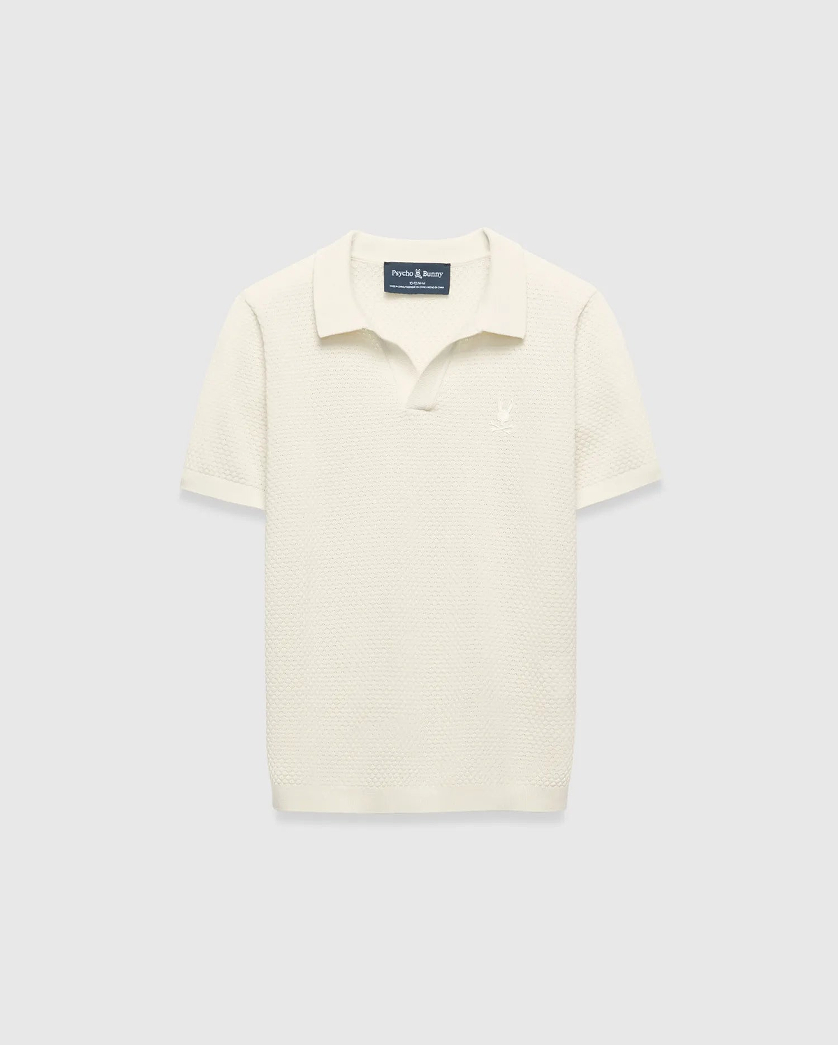Kids Devon Knit Polo in cream, featuring a textured knit fabric, classic fit, and a small tonal embroidered Psycho Bunny skull logo on the left chest.