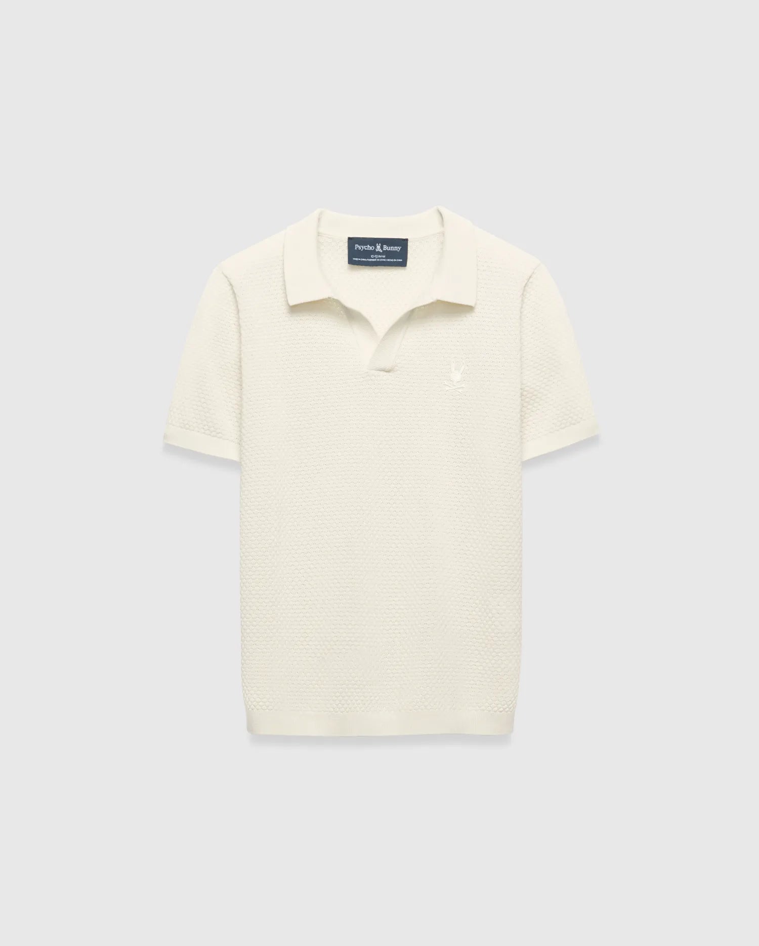 Kids Devon Knit Polo in cream, featuring a textured knit fabric, classic fit, and a small tonal embroidered Psycho Bunny skull logo on the left chest.