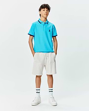 Kids Holden Pique Polo in bright blue, featuring a classic fit, pique texture, navy tipped collar and cuffs, and a small embroidered Psycho Bunny skull logo on the left chest.