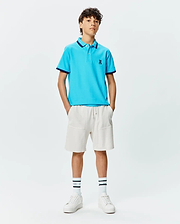 Kids Holden Pique Polo in bright blue, featuring a classic fit, pique texture, navy tipped collar and cuffs, and a small embroidered Psycho Bunny skull logo on the left chest.
