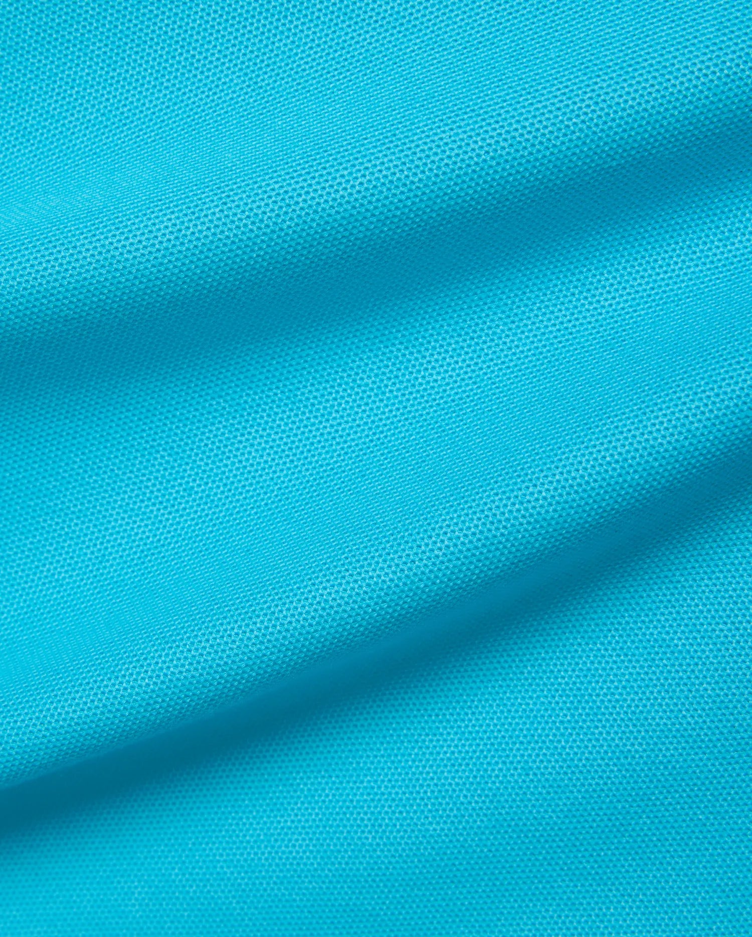 Kids Holden Pique Polo in vibrant aqua blue, crafted from breathable pique knit fabric, featuring the iconic small embroidered Psycho Bunny skull logo on the chest.