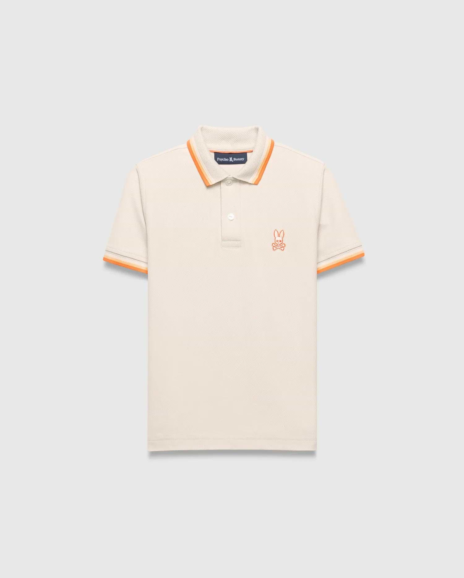 Kids Holden Pique Polo, a classic fit cream pique polo with orange striped ribbed collar and cuffs, featuring a small embroidered orange Psycho Bunny skull logo on the left chest.