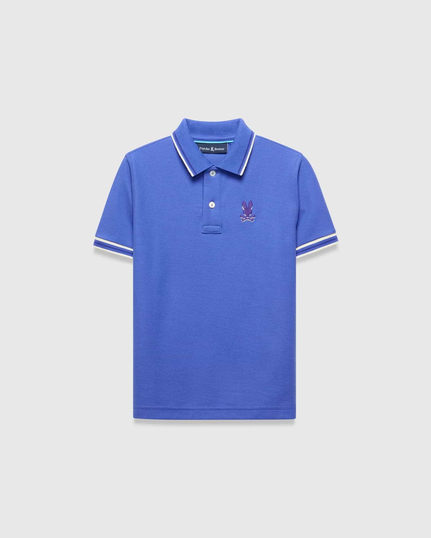 Kids Brad Pique Polo, royal blue classic fit pique polo with white tipped collar and cuffs, featuring a small embroidered purple Psycho Bunny skull logo on the left chest.