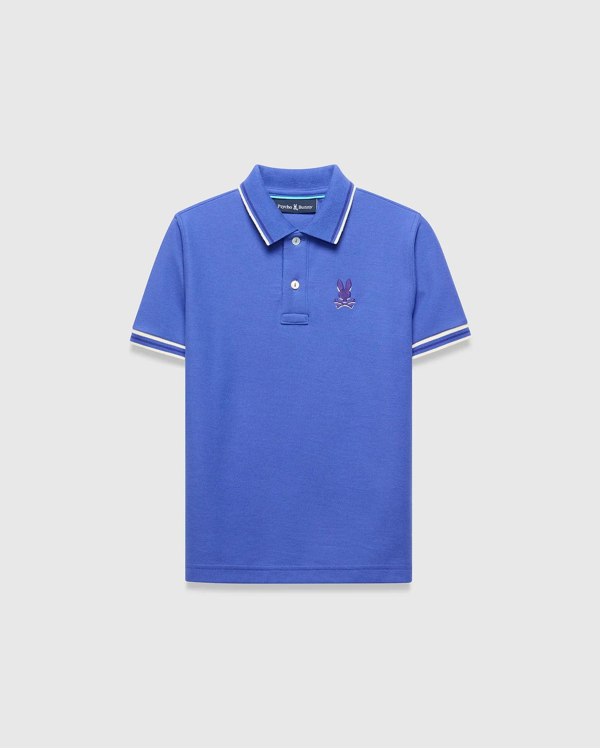 Kids Brad Pique Polo, royal blue classic fit pique polo with white tipped collar and cuffs, featuring a small embroidered purple Psycho Bunny skull logo on the left chest.