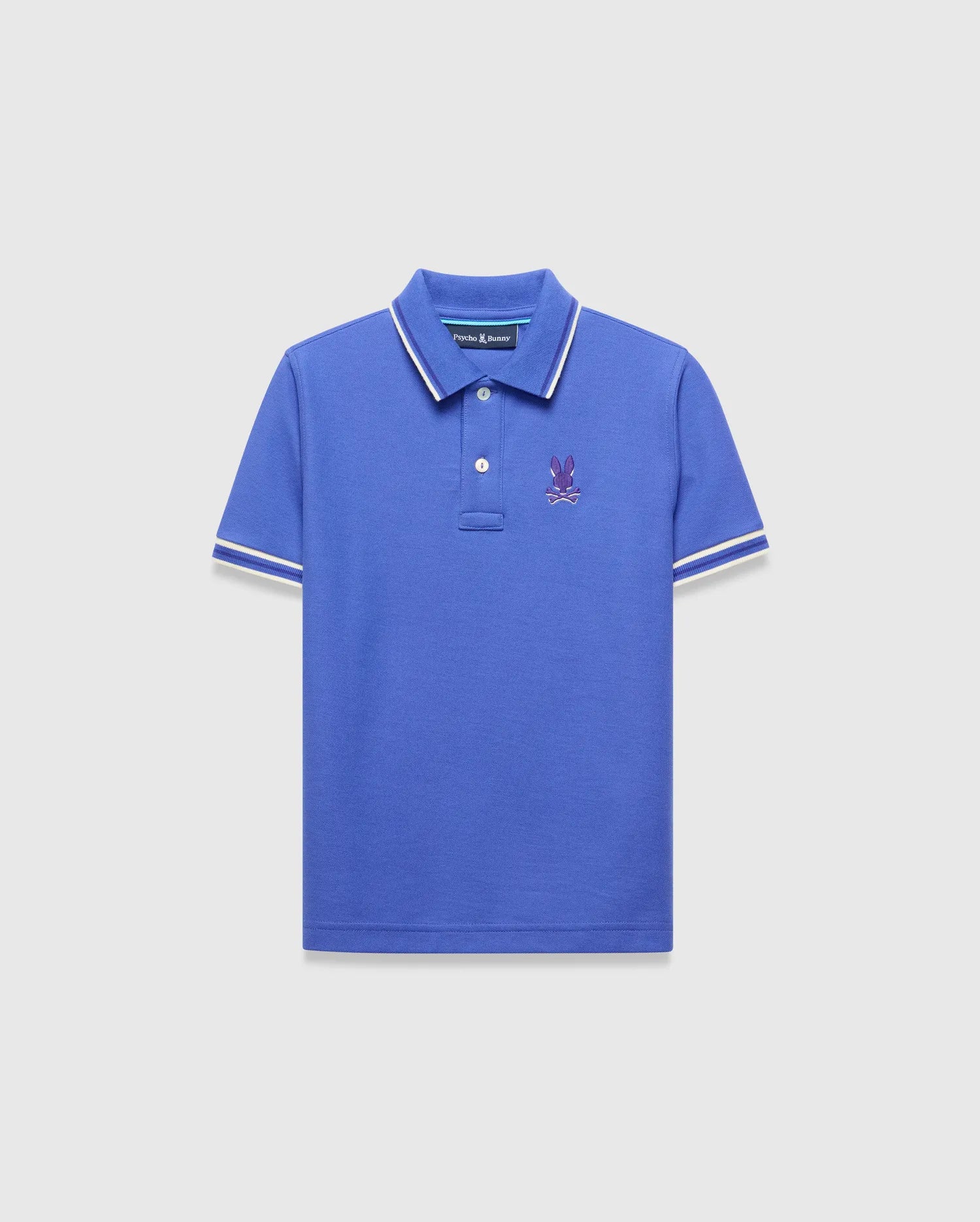 Kids Brad Pique Polo, royal blue classic fit pique polo with white tipped collar and cuffs, featuring a small embroidered purple Psycho Bunny skull logo on the left chest.