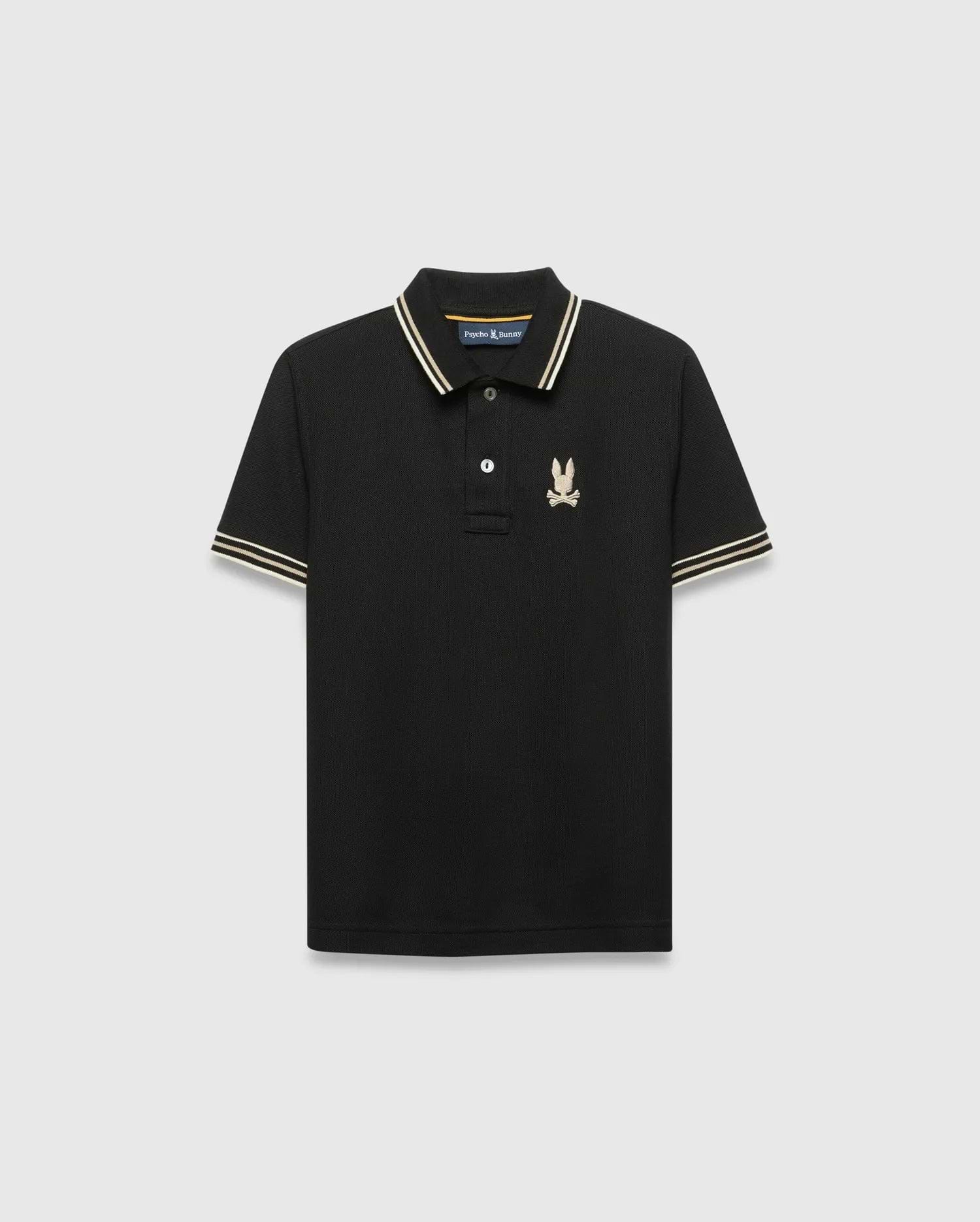 Kids Brad Pique Polo, black classic fit pique knit with gold-tan and white striped collar and cuffs, featuring a small embroidered gold Psycho Bunny skull logo on the left chest. (5)
