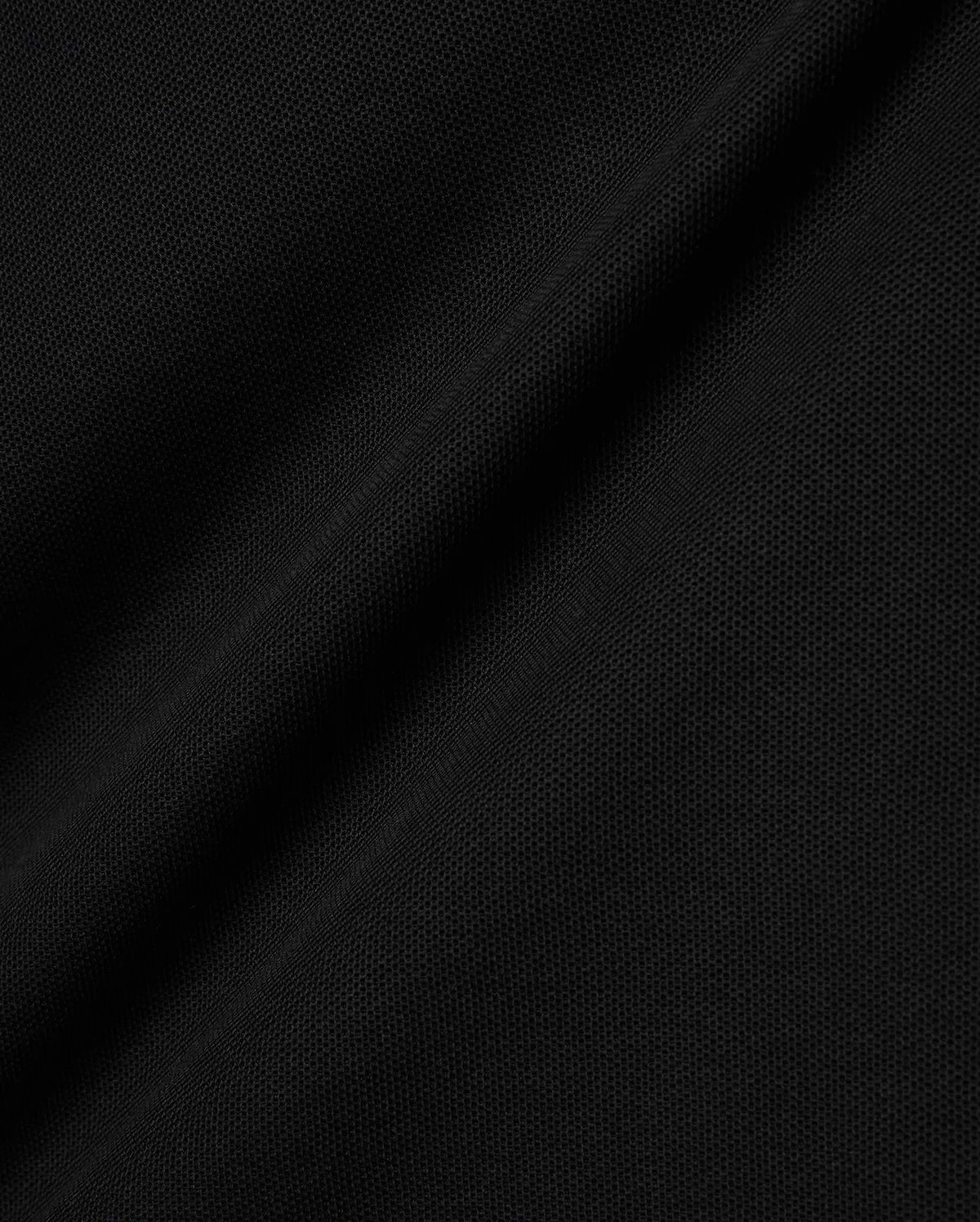 Black Kids Brad Pique Polo fabric, a close-up revealing the refined, breathable textured pique weave with subtle, elegant folds, perfect for premium Psycho Bunny menswear. (6)