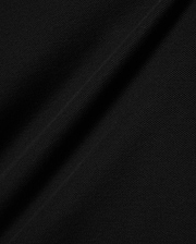 Black Kids Brad Pique Polo fabric, a close-up revealing the refined, breathable textured pique weave with subtle, elegant folds, perfect for premium Psycho Bunny menswear. (6)