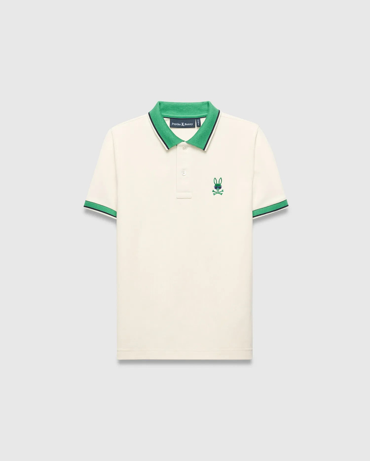 Kids Sunny Pique Polo in cream pique, classic fit, with a vibrant green collar, green and navy striped cuffs, and an embroidered green and blue Psycho Bunny skull logo on the left chest.