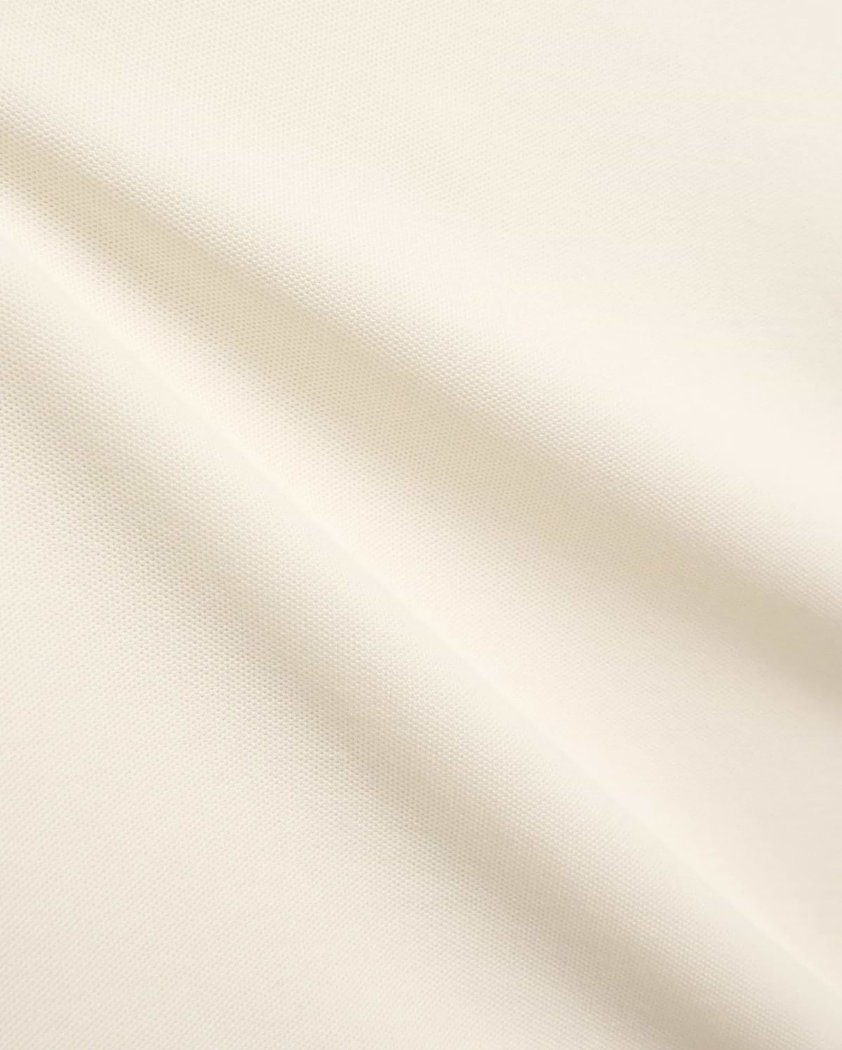 Kids Sunny Pique Polo, a creamy off-white shirt crafted from textured pique fabric, featuring the signature small embroidered Psycho Bunny skull logo on the left chest.